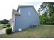 Home exterior featuring gray siding, well-kept lawn and central air conditioning units at 2307 Overlook Ave, Lithonia, GA 30058