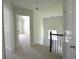 Bright hallway with carpeted floors and stairs leading to the upper level of the home at 2307 Overlook Ave, Lithonia, GA 30058