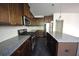 Stylish kitchen featuring granite countertops, stainless steel appliances, and wood cabinets at 2307 Overlook Ave, Lithonia, GA 30058