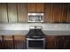 Updated kitchen with granite countertops, stainless steel appliances and wood cabinets at 2307 Overlook Ave, Lithonia, GA 30058