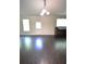 Large living room with door leading to the exterior and three windows at 2307 Overlook Ave, Lithonia, GA 30058