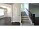 Inviting living room features dark wood floors, chandelier, and wainscoting at 2307 Overlook Ave, Lithonia, GA 30058