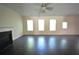 Bright living room with ceiling fan, fireplace, and three sunny windows at 2307 Overlook Ave, Lithonia, GA 30058