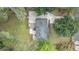 A bird's eye view showcases the house with a deck, surrounded by lush greenery and a well-maintained yard at 5725 Brenda Sw Dr, Mableton, GA 30126