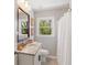 Cozy bathroom with granite countertops, decorative mirror, and a shower at 5725 Brenda Sw Dr, Mableton, GA 30126