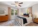 Cozy bedroom with a ceiling fan and natural light from multiple windows at 5725 Brenda Sw Dr, Mableton, GA 30126