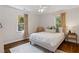 Bedroom featuring a bed, hardwood flooring, neutral walls, and two windows at 5725 Brenda Sw Dr, Mableton, GA 30126