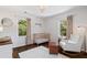 Bright Bedroom with a wooden crib, rocking chair, and hardwood floors at 5725 Brenda Sw Dr, Mableton, GA 30126