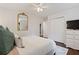 Bedroom with hardwood flooring, white walls, closet, and a white ceiling fan at 5725 Brenda Sw Dr, Mableton, GA 30126