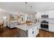 Stylish kitchen with white cabinets, granite countertops, a rustic island, and hardwood floors at 5725 Brenda Sw Dr, Mableton, GA 30126