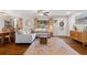Bright and airy living room with a large sectional sofa, hardwood floors, and natural light at 5725 Brenda Sw Dr, Mableton, GA 30126