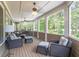 Relaxing screened porch with comfortable seating, ceiling fans, and panoramic views of the private backyard at 100 Trotters Ridge, Fayetteville, GA 30215