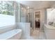 Spa-like bathroom with a glass-enclosed shower, soaking tub, modern fixtures and walk in closet at 100 Trotters Ridge, Fayetteville, GA 30215