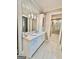 Well-lit bathroom featuring a large mirror, marble countertop, and white cabinetry at 100 Trotters Ridge, Fayetteville, GA 30215