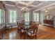 Elegant dining room with hardwood floors, coffered ceilings, and a chandelier at 100 Trotters Ridge, Fayetteville, GA 30215