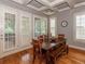 Bright dining area with hardwood floors, natural light, and stylish dining furniture; ideal for Gathering gatherings at 100 Trotters Ridge, Fayetteville, GA 30215