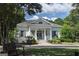 Charming one-story home with a welcoming front porch, white columns, and beautiful landscaping at 100 Trotters Ridge, Fayetteville, GA 30215