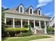Elegant home featuring a covered front porch with stately columns, stone stairs, and meticulously maintained landscaping at 100 Trotters Ridge, Fayetteville, GA 30215