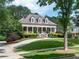 Beautiful home with a welcoming front porch, lush green lawn, mature trees, and a convenient circular driveway at 100 Trotters Ridge, Fayetteville, GA 30215