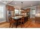Spacious kitchen with stainless steel appliances, custom cabinetry, center island with breakfast bar, and hardwood floors at 100 Trotters Ridge, Fayetteville, GA 30215