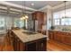 Open concept kitchen with granite countertops, stainless steel appliances, a center island with gas cooktop, and hardwood floors at 100 Trotters Ridge, Fayetteville, GA 30215