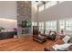 Spacious living room featuring a stone fireplace, high ceilings, and plentiful natural light at 100 Trotters Ridge, Fayetteville, GA 30215
