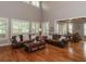 Large living room with hardwood floors, lots of natural light, and cozy seating area at 100 Trotters Ridge, Fayetteville, GA 30215