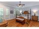 Luxurious main bedroom with hardwood floors and french doors to outside at 100 Trotters Ridge, Fayetteville, GA 30215