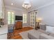 Bright home office featuring a barn door, custom desk, and comfortable seating area at 100 Trotters Ridge, Fayetteville, GA 30215