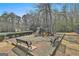 Community playground area with slides, climbing structures, and benches surrounded by greenery at 100 Trotters Ridge, Fayetteville, GA 30215