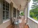 Inviting covered porch furnished with comfortable seating, stylish decor, and views of the serene surroundings at 100 Trotters Ridge, Fayetteville, GA 30215