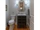 Stylish powder room with a modern vanity, framed mirror, and sconce lighting at 100 Trotters Ridge, Fayetteville, GA 30215