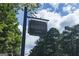 Entrance sign to the Highgrove community, established in 1996, surrounded by lush trees and a clear sky at 100 Trotters Ridge, Fayetteville, GA 30215