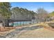 Community tennis courts surrounded by lush landscaping and mature trees on a sunny day at 100 Trotters Ridge, Fayetteville, GA 30215