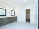 Spacious bathroom with double vanity, walk-in shower, and ample storage with cabinets and natural light at 2109 Ella Springs Dr, Covington, GA 30014