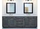 Bathroom features a double vanity with gray cabinets, white countertops, modern fixtures, and decorative mirrors at 2109 Ella Springs Dr, Covington, GA 30014
