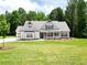 Inviting single-story home with a brick facade, gabled roof, and well-manicured lawn and professional landscaping at 2109 Ella Springs Dr, Covington, GA 30014