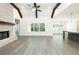Bright living room with vaulted ceiling, wood beams, brick fireplace, and ample natural light from large windows at 2109 Ella Springs Dr, Covington, GA 30014