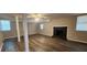 Spacious basement featuring a black brick fireplace, windows and wood look floors at 2663 Washington Nw St, Atlanta, GA 30318