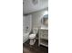 Bright bathroom featuring white vanity, round mirror, and modern fixtures, alongside a tub and shower combination at 2663 Washington Nw St, Atlanta, GA 30318
