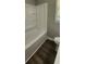 White shower/bath with a window and matching toilet at 2663 Washington Nw St, Atlanta, GA 30318