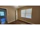Bedroom with wood floors, double window with blinds, and an interior door at 2663 Washington Nw St, Atlanta, GA 30318
