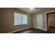 Bedroom with hardwood floors, a window with blinds, and a white door at 2663 Washington Nw St, Atlanta, GA 30318