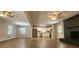 Bright open-concept living space with hardwood floors, a modern kitchen, and a brick fireplace at 2663 Washington Nw St, Atlanta, GA 30318
