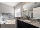 Bathroom featuring a soaking tub, modern vanity with granite countertops, and natural light at 2767 Durham Ne Dr, Atlanta, GA 30319