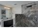 Modern bathroom featuring marble-tiled shower, granite countertop vanity, and sleek fixtures at 2767 Durham Ne Dr, Atlanta, GA 30319