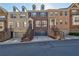 Street view of brick townhomes with garage parking and manicured landscaping at 2767 Durham Ne Dr, Atlanta, GA 30319