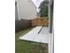 Concrete walkway and grass leading to side gate in backyard at 4805 Madison Point Cir, Austell, GA 30106