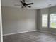 Bright bedroom with new floors, a ceiling fan, and natural light from multiple windows at 4805 Madison Point Cir, Austell, GA 30106