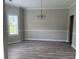 Dining room with new floors, large window, and elegant chandelier at 4805 Madison Point Cir, Austell, GA 30106